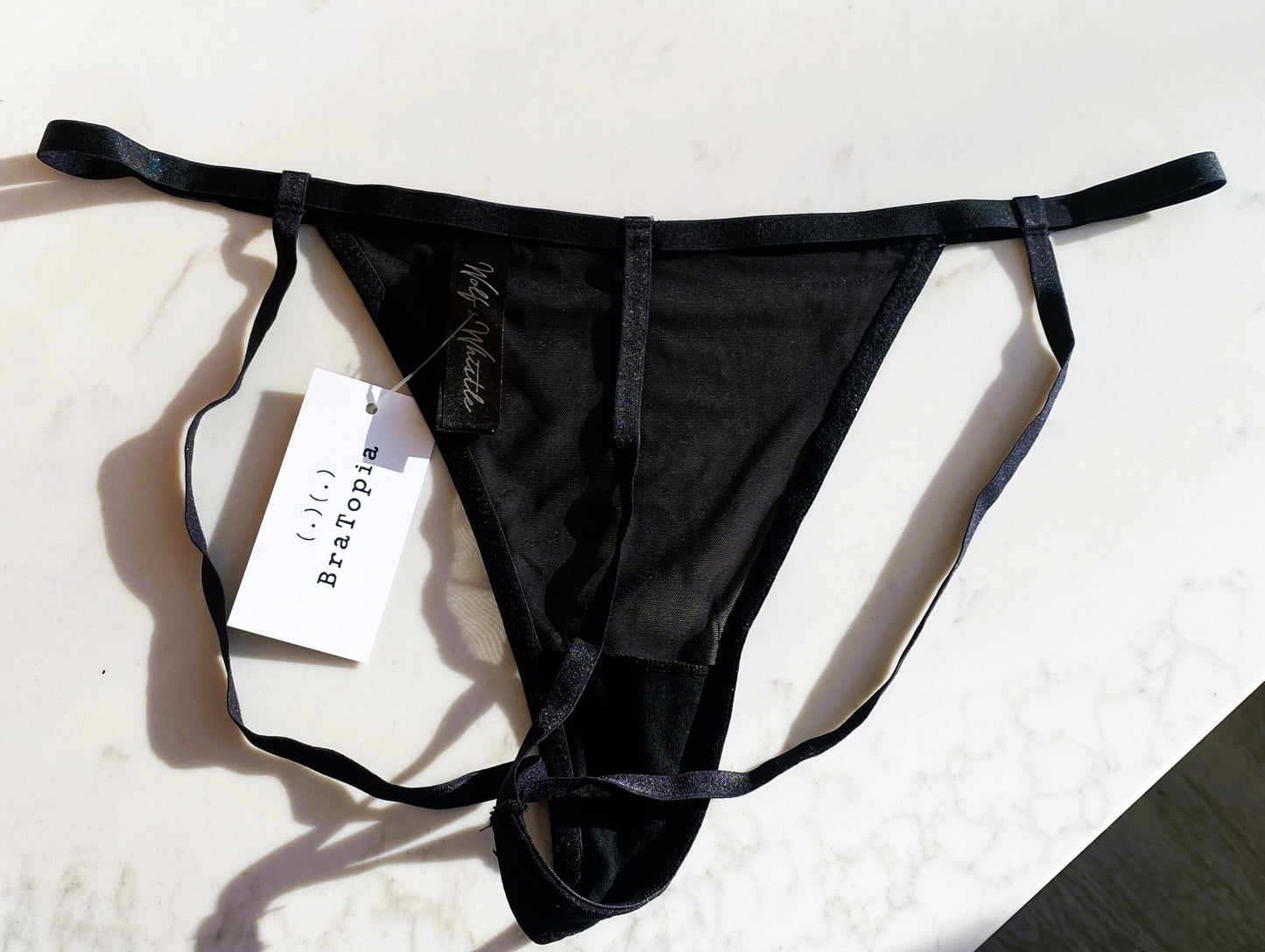 Kiera Panty In Black - Playful Promises, back view of product picture with BraTopia tag on it